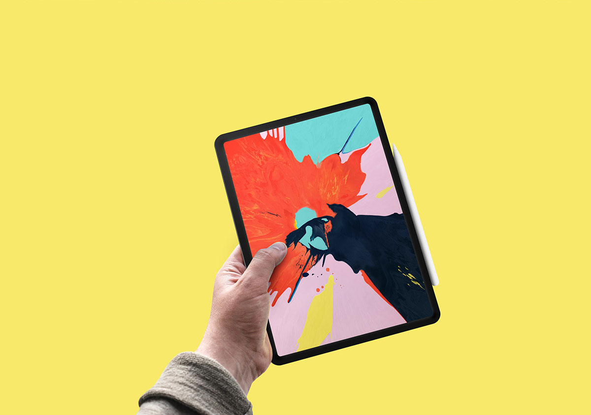iPad Pro with Apple Pencil Held by a Hand PSD Mockup FREE PSD