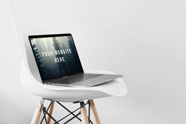 Open MacBook Pro on a Chair Mockup FREE PSD