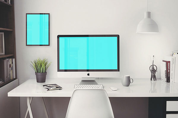 The mockup of an iMac Retina 5k on a desk next to a plant FREE PSD