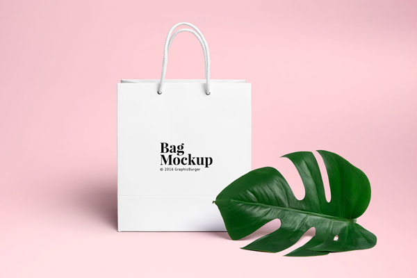 White Shopping Bag beside a Large Leaf Mockup FREE PSD