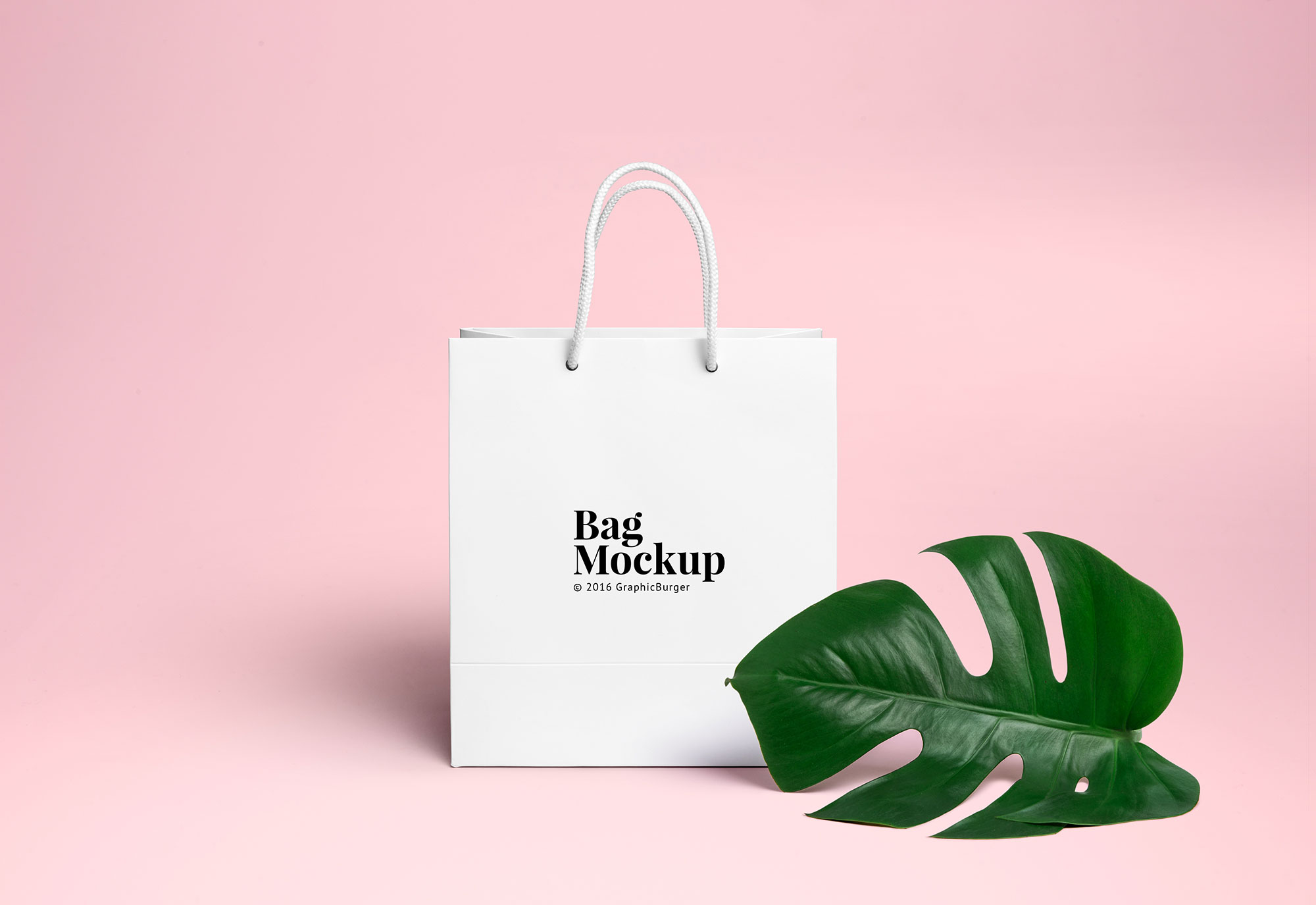 White Shopping Bag beside a Large Leaf Mockup FREE PSD