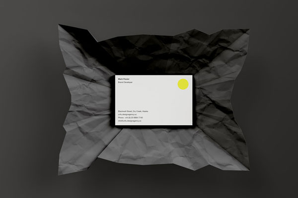 A Business Card Wrapped in Wrinkled Paper Mockup FREE PSD