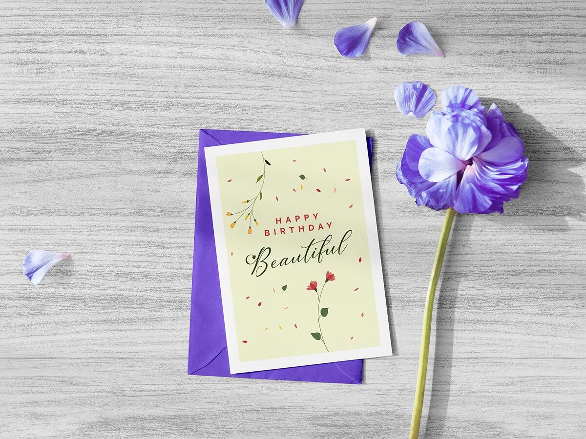Greeting Card and Envelope Mockup Next to a Flower FREE PSD