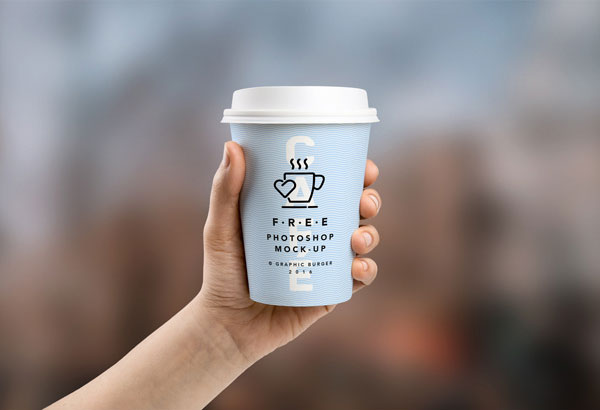 Hand Holding Coffee Cups in Two Sizes Mockup FREE PSD