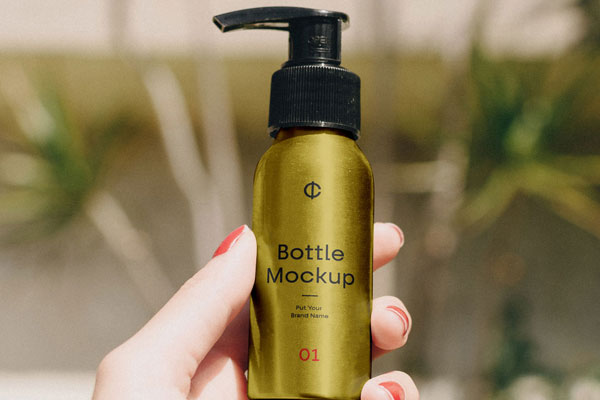 Metal Bottle In A Hand With A Floral Background Mockup FREE PSD