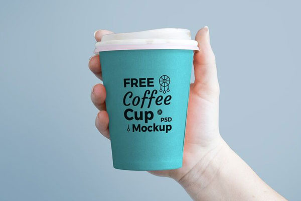 Mockup Featuring Front View of Hand Holding Paper Coffee Cup FREE PSD