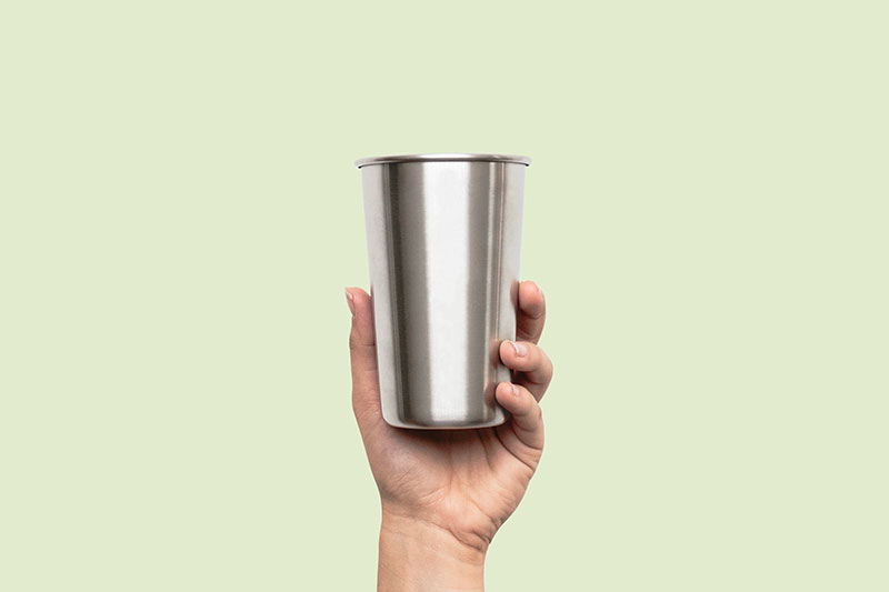 Mockup of a Metal Cup Held Up in the air FREE PSD