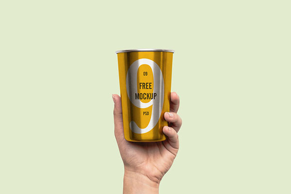 Mockup of a Metal Cup Held Up in the air FREE PSD