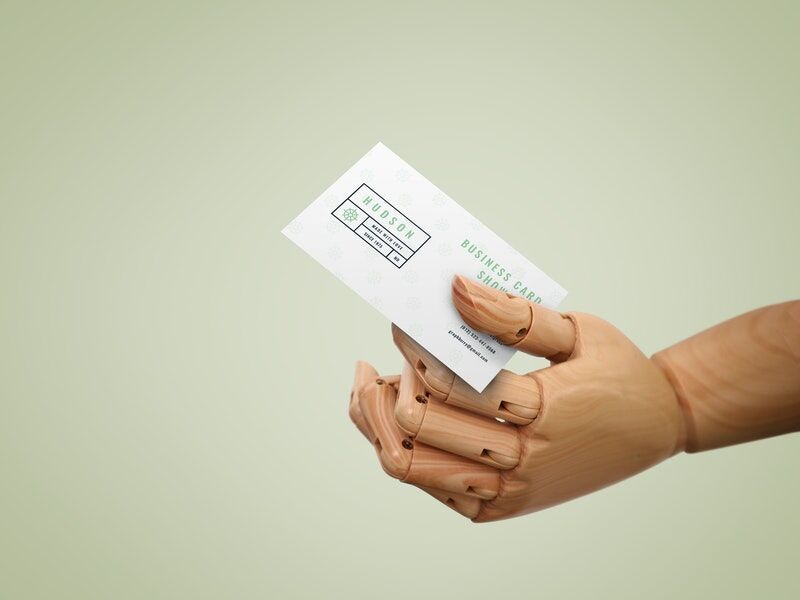 Wooden Hand Handing Out a Business CardMockup FREE PSD