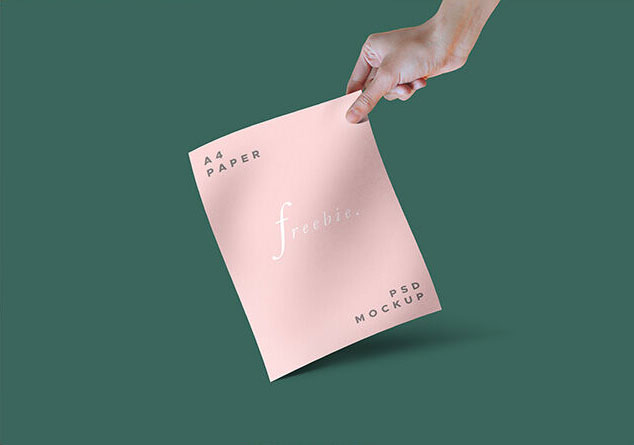 A Stylish Mockup of a Hand holding a Paper or a Magazine FREE PSD