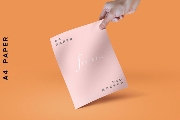 A Stylish Mockup of a Hand holding a Paper or a Magazine FREE PSD