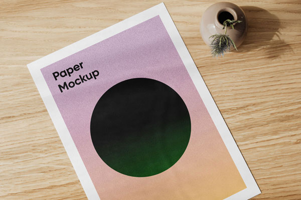 A4 Card on a Wooden Table Beside a Vase Mockup FREE PSD