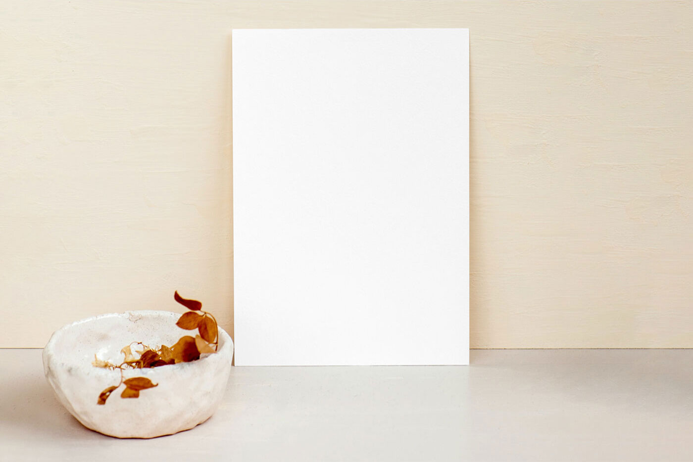 A4 Paper against Wall beside a Bowl Containing Dried Leaves Mockup FREE PSD