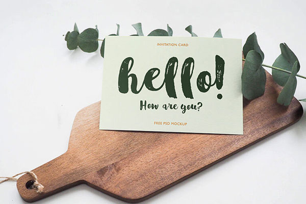 Invitation Card Laid on a Wooden Board Mockup FREE PSD