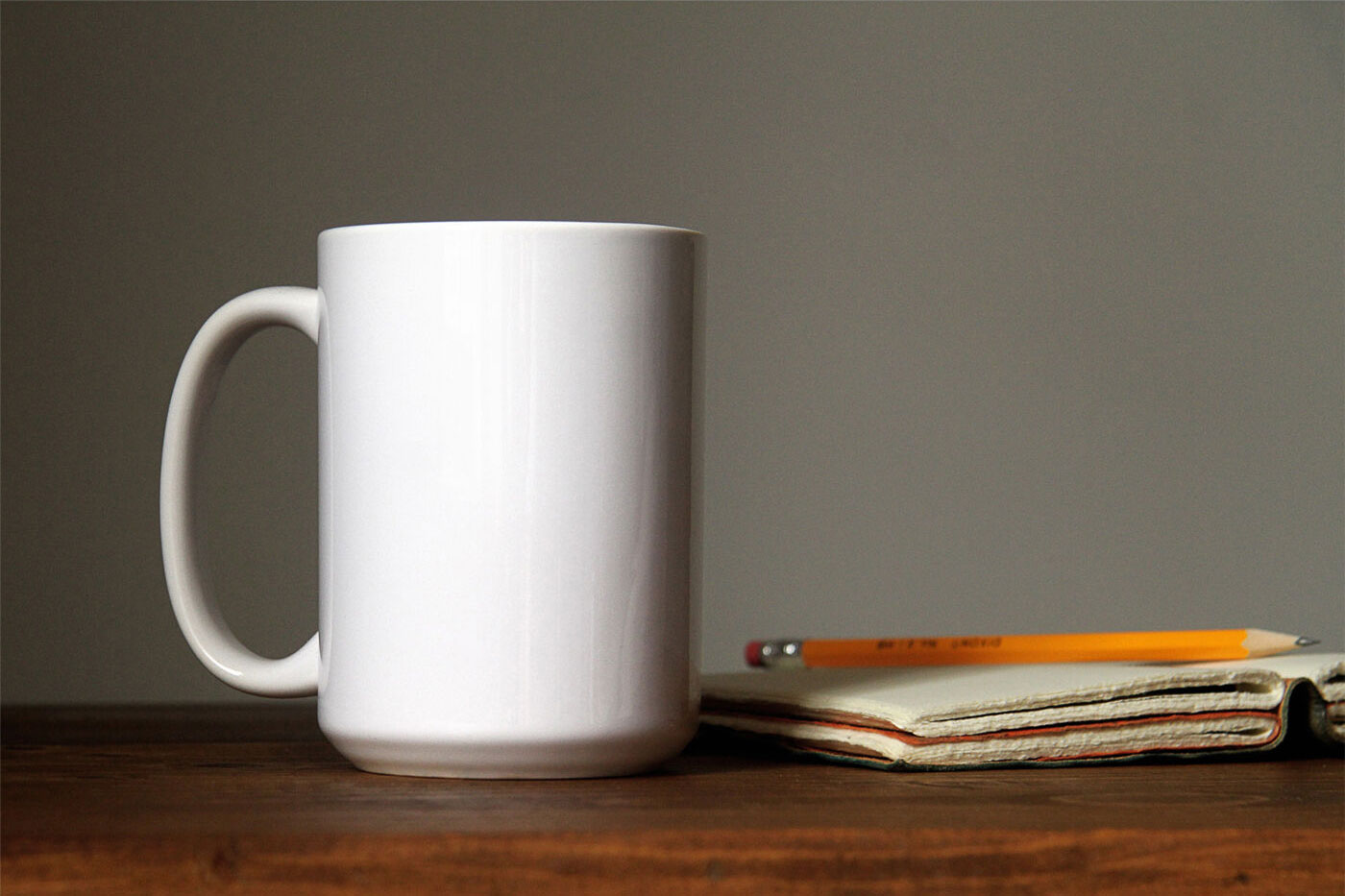 Mockup Featuring Front View of a Coffee Mug on a Wooden Table FREE PSD