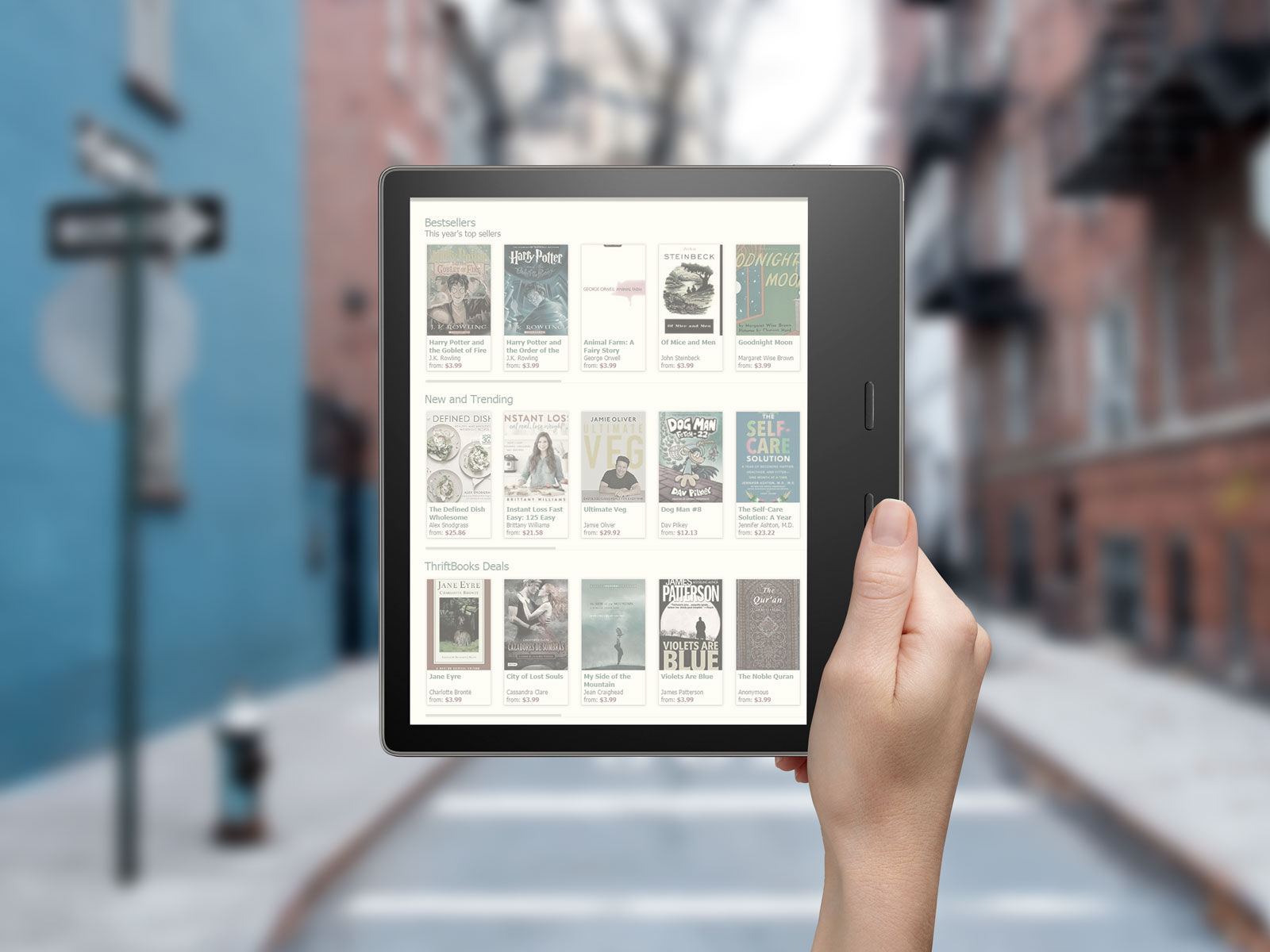 Mockup Featuring Hand Holding a Kindle Oasis E-Reader FREE PSD