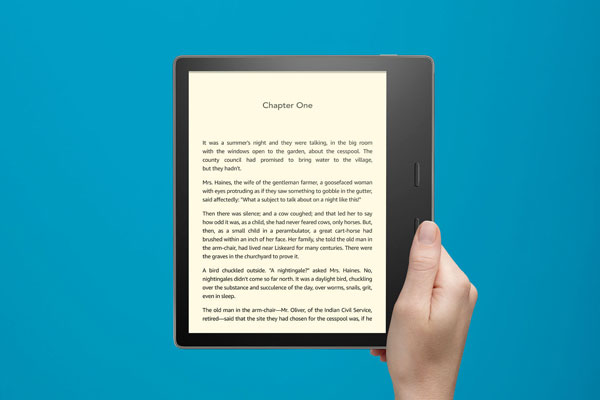 Mockup Featuring Hand Holding a Kindle Oasis E-Reader FREE PSD
