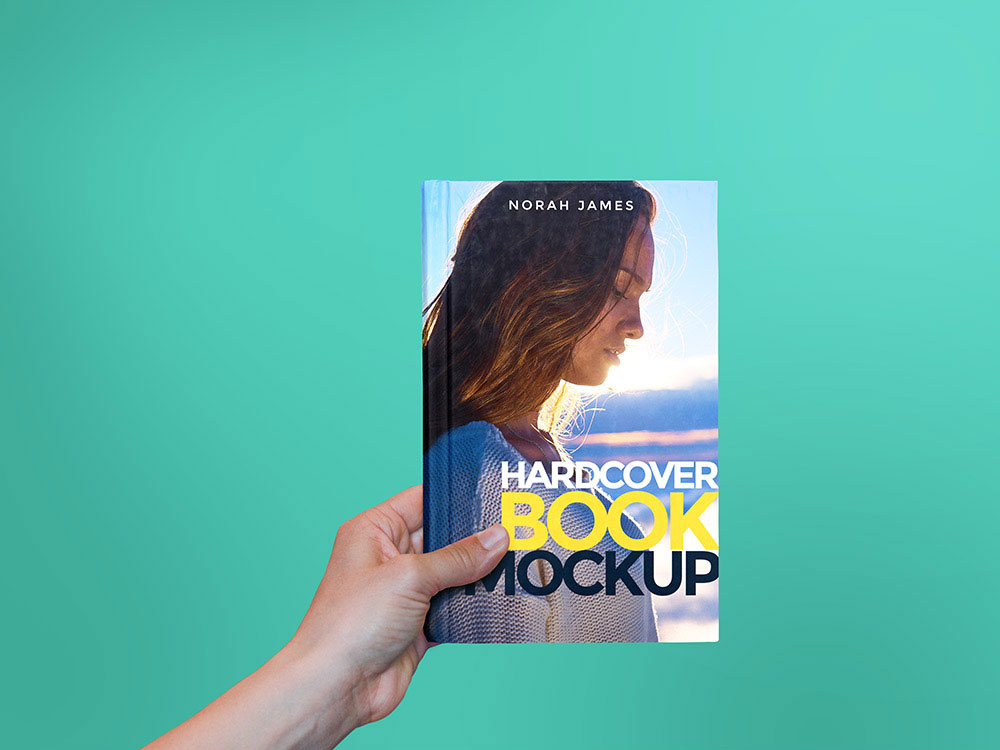 Mockup of a Hand Offering a Hard-cover Book FREE PSD