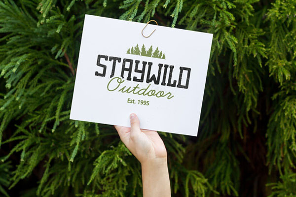 Mockup of a Person's Hand Holding Up a Card in the Air FREE PSD