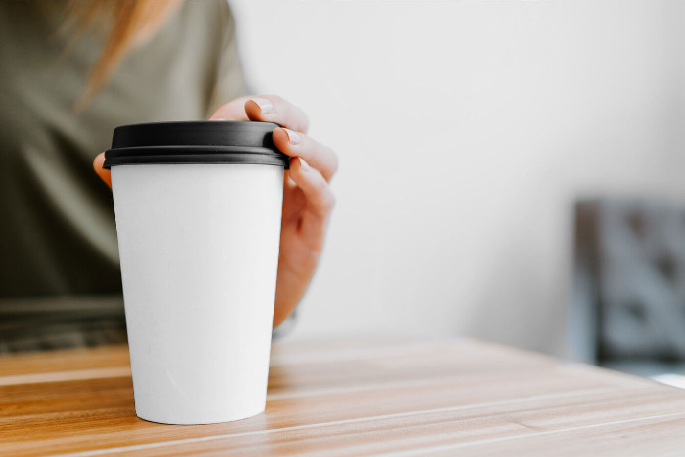 Mockup of Coffee Cup Held by a Woman FREE PSD