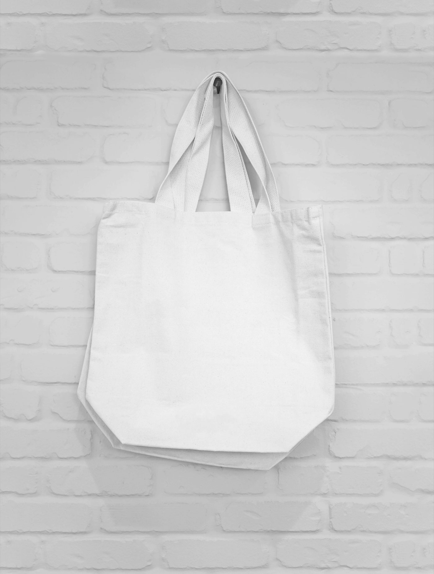 Mockup of Two Canvas Bags Hanging on a Nail FREE PSD