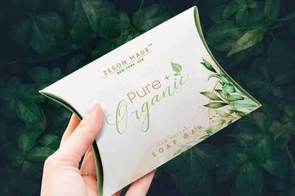 Mockup Showing a Hand Holding a Pillow Box Packaging FREE PSD