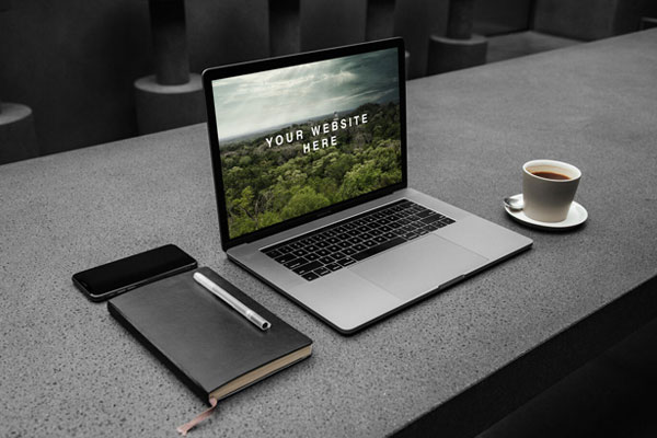 Opened MacBook On A Workspace Mockup FREE PSD