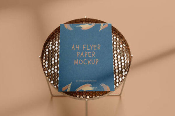 A4 Flyer Mockup in the Overhead View Featuring a Round Side Table FREE PSD
