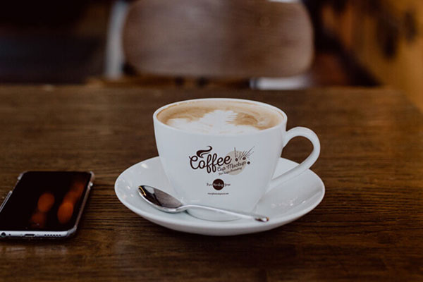 Coffee Cup with Plate on Wooden Table Mockup FREE PSD
