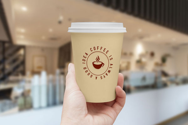 Mockup Featuring a Hand Holding a Coffee Cup with Lid FREE PSD
