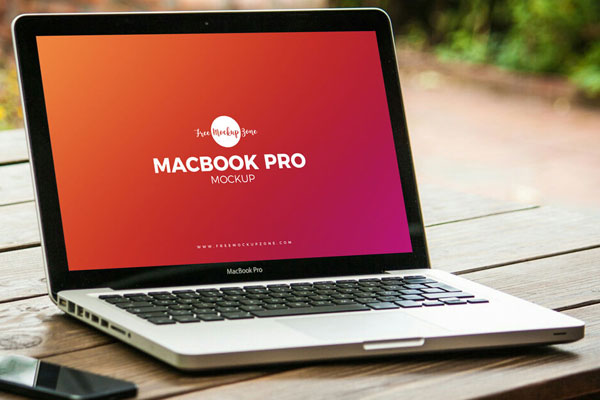 Mockup Featuring MacBook Pro on Wooden Table with Side View FREE PSD