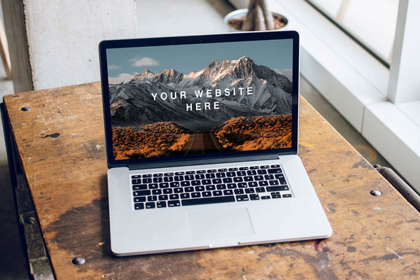 Mockup Featuring Open MacBook Pro on a Wooden Desk FREE PSD