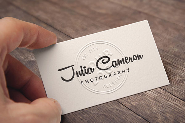 Mockup of a Hand Holding an Embossed Business Card FREE PSD