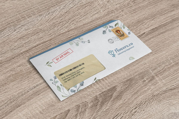 Mockup of a Windowed Envelope Lying on a Wooden Surface FREE PSD