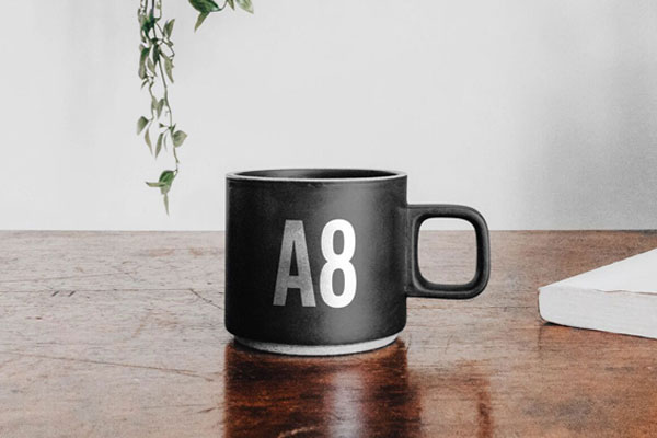 Mug On Table Mockup With A Book FREE PSD