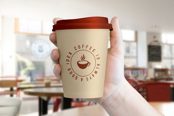 Realistic Mockup Showing Hand Holding a Coffee Cup with Lid FREE PSD
