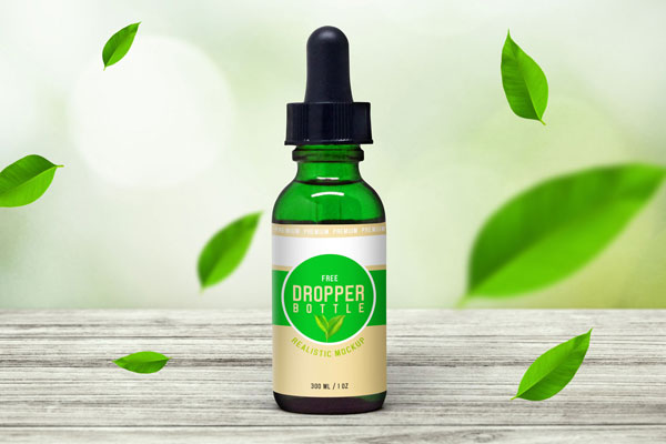 Front View of Glass Dropper Bottle on Wooden Surface Mockup FREE PSD