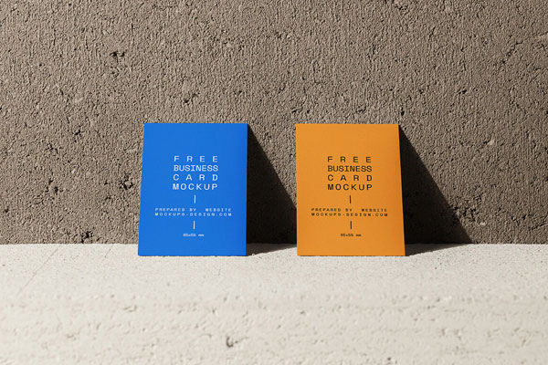 Front View of Two Vertical Business Cards against Concrete Wall Mockup FREE PSD