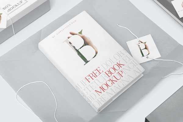 Mockup Featuring a Hardcover Book on Wrapping Paper with Tag and Box FREE PSD