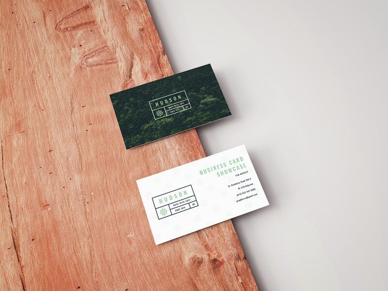 Mockup Featuring Two Business Cards Laid on Wooden Board in Perspective FREE PSD