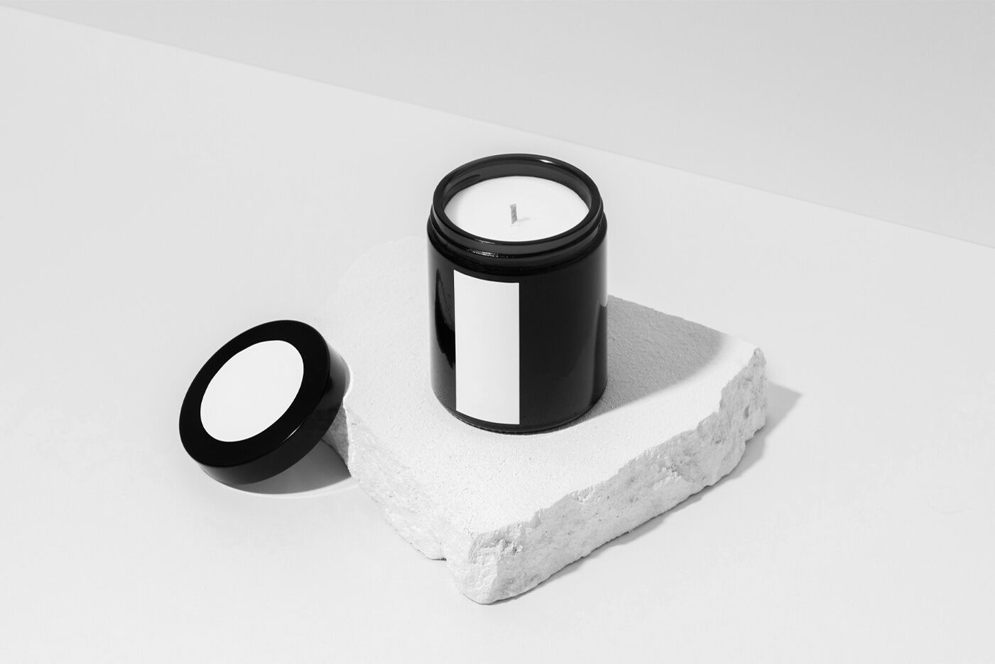 Mockup of a Candle Placed on a Piece of Stone FREE PSD