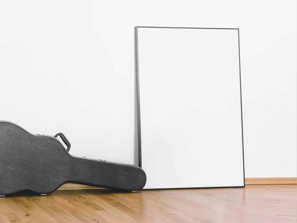 Mockup Showcasing Side View of Poster against Wall Beside Guitar Case FREE PSD