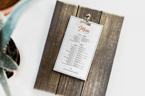 Mockup Showing a Restaurant Menu Card on a Wooden Board FREE PSD