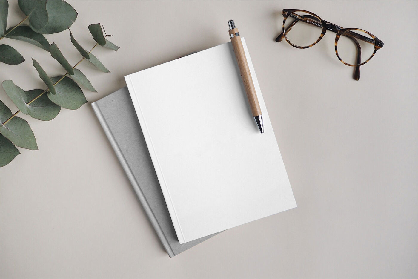 Notebook Mockup Featuring A Pen And A Glasses FREE PSD