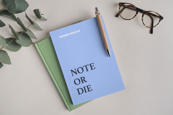 Notebook Mockup Featuring A Pen And A Glasses FREE PSD