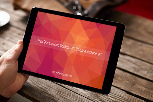Tablet Hand Mockup Wooden Blurred Background FREE PSD