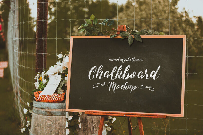 3/4 View Chalkboard in Outdoor Setting Mockup with Flowers FREE PSD
