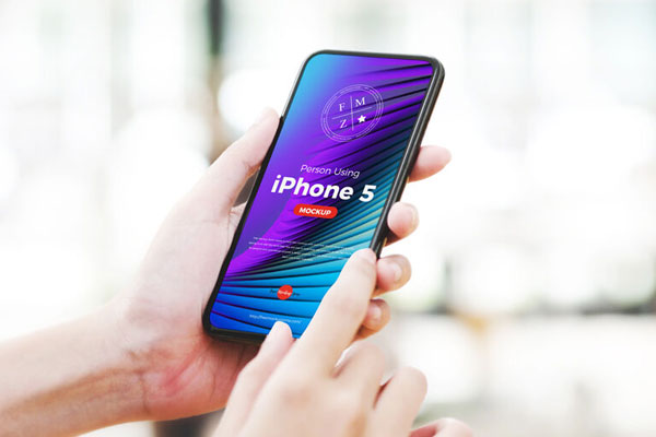 3/4 View Person Using iPhone 5 Mockup FREE PSD
