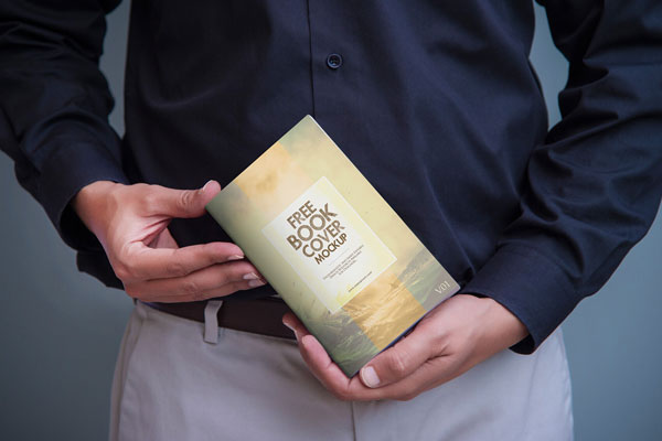 A Book Cover Mockup Held by a Man FREE PSD