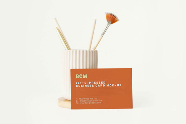 Front View Business Card Leaning Against Ceramic Brush Holder Mockup FREE PSD